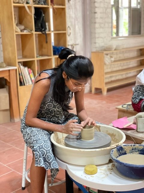 Sloka working clay at the pottery wheel