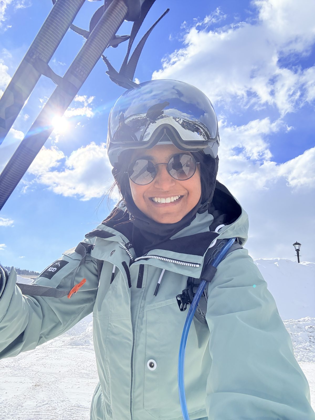 Sloka in ski gear and goggles on a snowy mountain